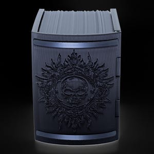May include: Black card deck box with a skull and sun design.