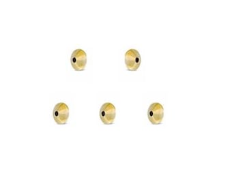 May include: Five gold-coloured round beads with a small hole in the centre.