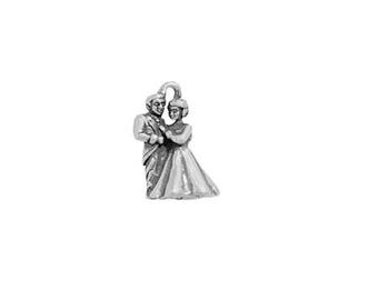 May include: A silver-toned charm depicting a couple in formal attire, likely a bride and groom. The woman wears a long gown, and the man is in a suit. The charm is detailed and likely made of metal, perfect for jewelry or craft projects.
