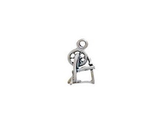 May include: Silver spinning wheel charm. The charm is a small, detailed representation of a spinning wheel with a wheel and a base.