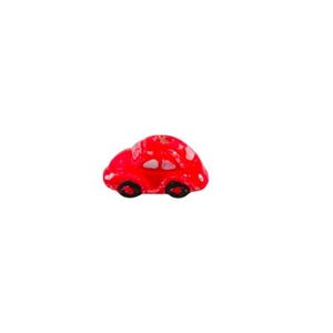 May include: Red plastic car bead with white details. The bead has black wheels and a hole in the top for stringing.