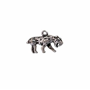 May include: Silver charm of a saber-toothed cat with black spots. The charm is in a walking pose with its mouth open and fangs showing.