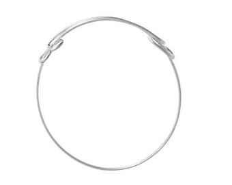 May include: A silver bangle bracelet with a simple, circular design. The bracelet is made of thin metal and has a smooth finish.
