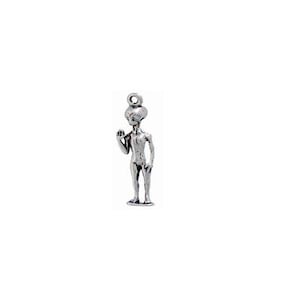 May include: A silver charm in the shape of a standing alien with large eyes and a rounded head.