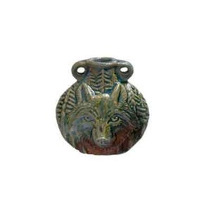May include: A ceramic vase with a wolf face design. The vase is round with a textured surface and two small handles. The wolf's face is detailed with green, brown, and red hues, and the top has a fern-like pattern.