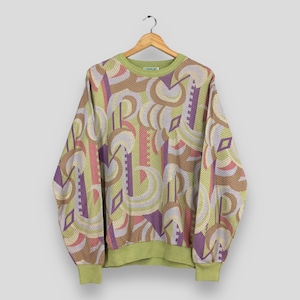 May include: A long-sleeved sweatshirt with a geometric pattern in shades of green, brown, purple, and pink. The sweatshirt is hanging on a wooden hanger against a white background. The cuffs and neckline are a solid green color.