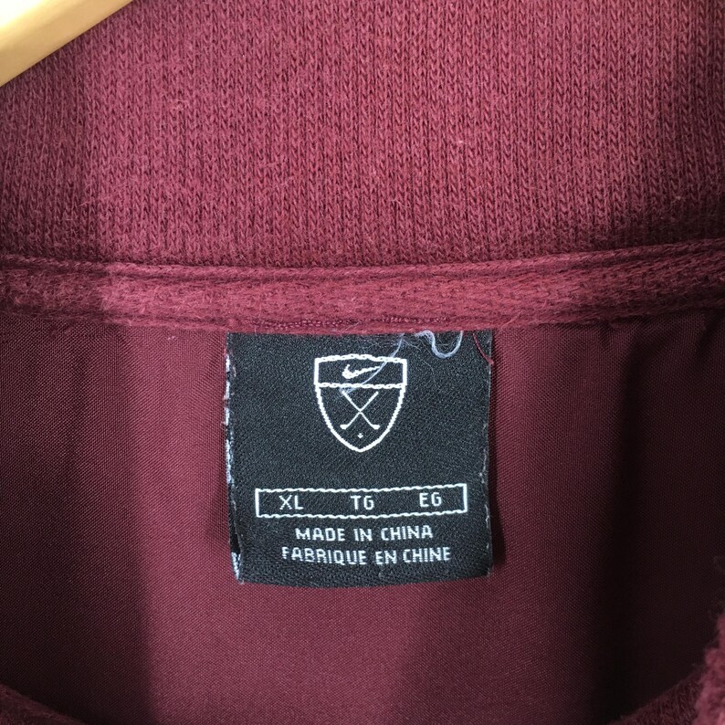 May include: A white ceramic mug with a black handle and the text "But First, Coffee" in a black, bold font. The mug is on a white surface.