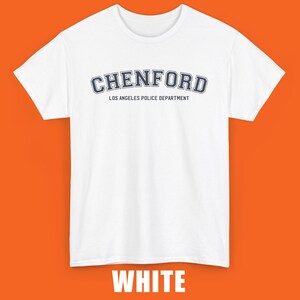 May include: White t-shirt with a navy blue "Chenford" graphic and the text "Los Angeles Police Department" underneath.