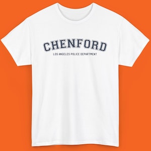 May include: White t-shirt with a navy blue graphic that says "CHENFORD LOS ANGELES POLICE DEPARTMENT" in an arched font.