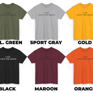 May include: Six t-shirts in different colors, each with the text "I said I LOVE THE SMITH" printed on the front. The colors are military green, sport gray, gold, black, maroon, and orange.