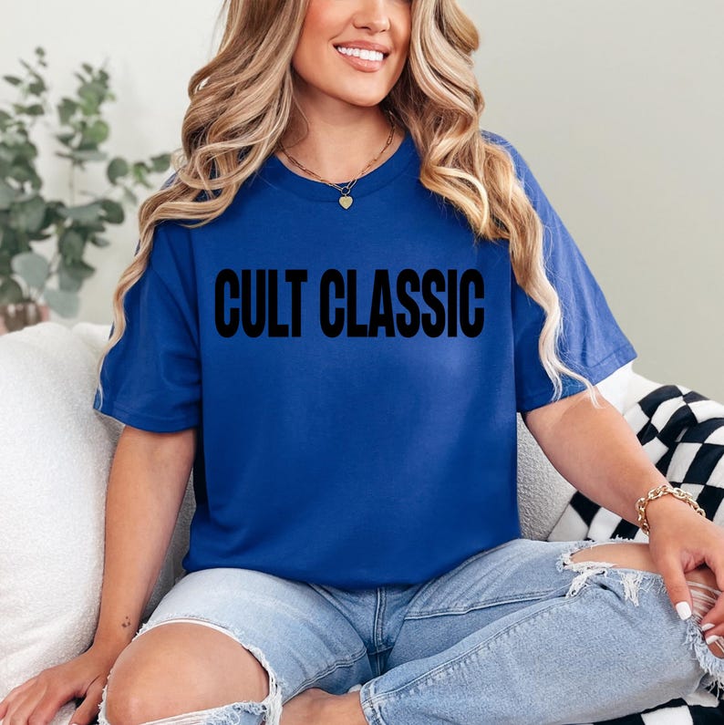 May include: A royal blue t-shirt with the text "CULT CLASSIC" printed in black.