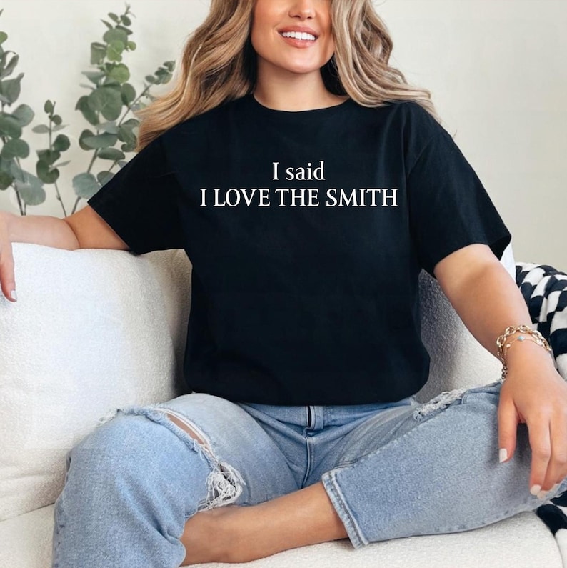 May include: A black t-shirt with white text that reads "I said I LOVE THE SMITH".