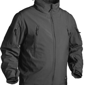 May include: A dark grey softshell jacket with a high collar and several zipped pockets. The jacket has a full-length zip, sleeve pockets, and adjustable cuffs. The design is streamlined and practical, suitable for outdoor pursuits.