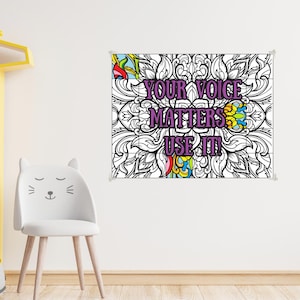 May include: A rectangular wall poster featuring a black and white intricate mandala pattern with the purple text "YOUR VOICE MATTERS. USE IT!" centered in the middle. Some sections of the mandala are colored in bright blue, yellow, and red.