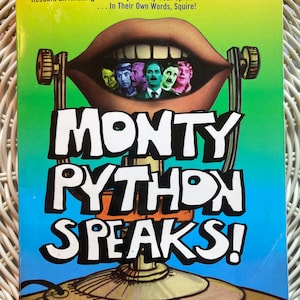May include: A book cover for "Monty Python Speaks!" features a large, cartoonish mouth with the faces of the Monty Python cast inside. The title is in large, white, stylized letters. The cover has a blue, green, and yellow color scheme.