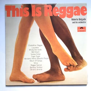 May include: A vintage vinyl record cover featuring a couple dancing with the title "This Is Reggae" and the artist "Roberto Delgado and his orchestra". The cover art features a close-up of the couple's feet, with the man's foot on top of the woman's foot.