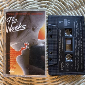 May include: A vintage cassette tape and case for the "9 1/2 Weeks" original motion picture soundtrack. The case features a romantic image and the title. The cassette tape is black with white text and a list of songs.