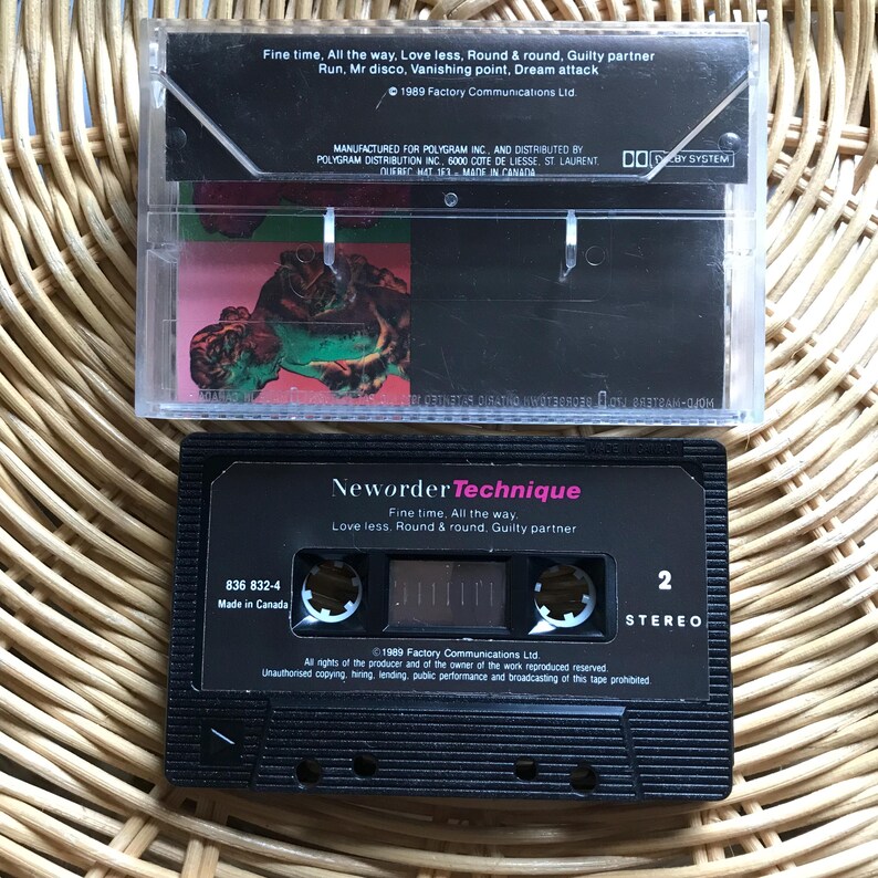 May include: A black cassette tape with a white label. The label has the text "Neworder Technique" and "Fine time, All the way. Love less. Round & round. Guilty partner." The cassette tape is made in Canada and has the number 836 832-4 printed on it.