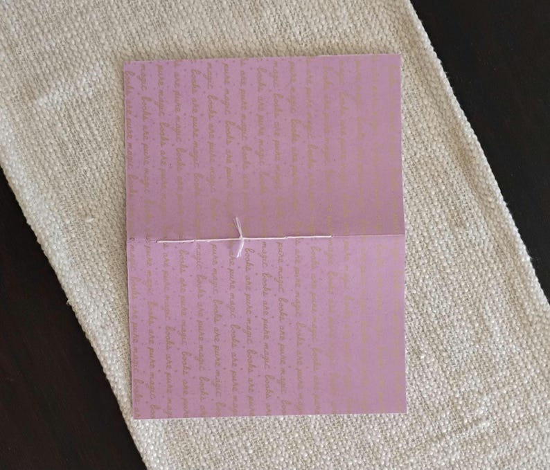 A handmade Bible study journal with a faith-inspired design. The cover features hand-lettered scripture, floral accents, and soft pastel tones. Inside, the journal includes lined, dotted, and blank pages for note-taking, prayer journaling, and reflection. Divider tabs help organize scripture studies, sermon notes, and daily devotions. Ideal for personal use or gifting, this thoughtful journal encourages spiritual growth and creativity.