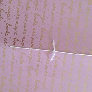 A handmade Bible study journal with a faith-inspired design. The cover features hand-lettered scripture, floral accents, and soft pastel tones. Inside, the journal includes lined, dotted, and blank pages for note-taking, prayer journaling, and reflection. Divider tabs help organize scripture studies, sermon notes, and daily devotions. Ideal for personal use or gifting, this thoughtful journal encourages spiritual growth and creativity.