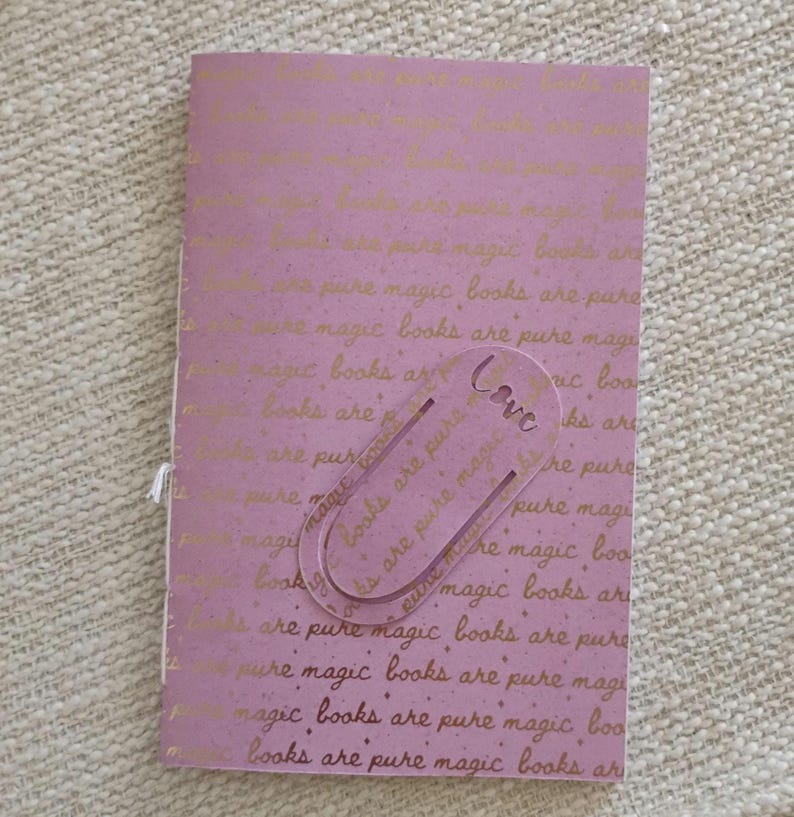 A handmade Bible study journal with a faith-inspired design. The cover features hand-lettered scripture, floral accents, and soft pastel tones. Inside, the journal includes lined, dotted, and blank pages for note-taking, prayer journaling, and reflection. Divider tabs help organize scripture studies, sermon notes, and daily devotions. Ideal for personal use or gifting, this thoughtful journal encourages spiritual growth and creativity.