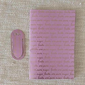 A handmade Bible study journal with a faith-inspired design. The cover features hand-lettered scripture, floral accents, and soft pastel tones. Inside, the journal includes lined, dotted, and blank pages for note-taking, prayer journaling, and reflection. Divider tabs help organize scripture studies, sermon notes, and daily devotions. Ideal for personal use or gifting, this thoughtful journal encourages spiritual growth and creativity.