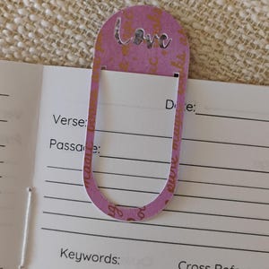 A handmade Bible study journal with a faith-inspired design. The cover features hand-lettered scripture, floral accents, and soft pastel tones. Inside, the journal includes lined, dotted, and blank pages for note-taking, prayer journaling, and reflection. Divider tabs help organize scripture studies, sermon notes, and daily devotions. Ideal for personal use or gifting, this thoughtful journal encourages spiritual growth and creativity.