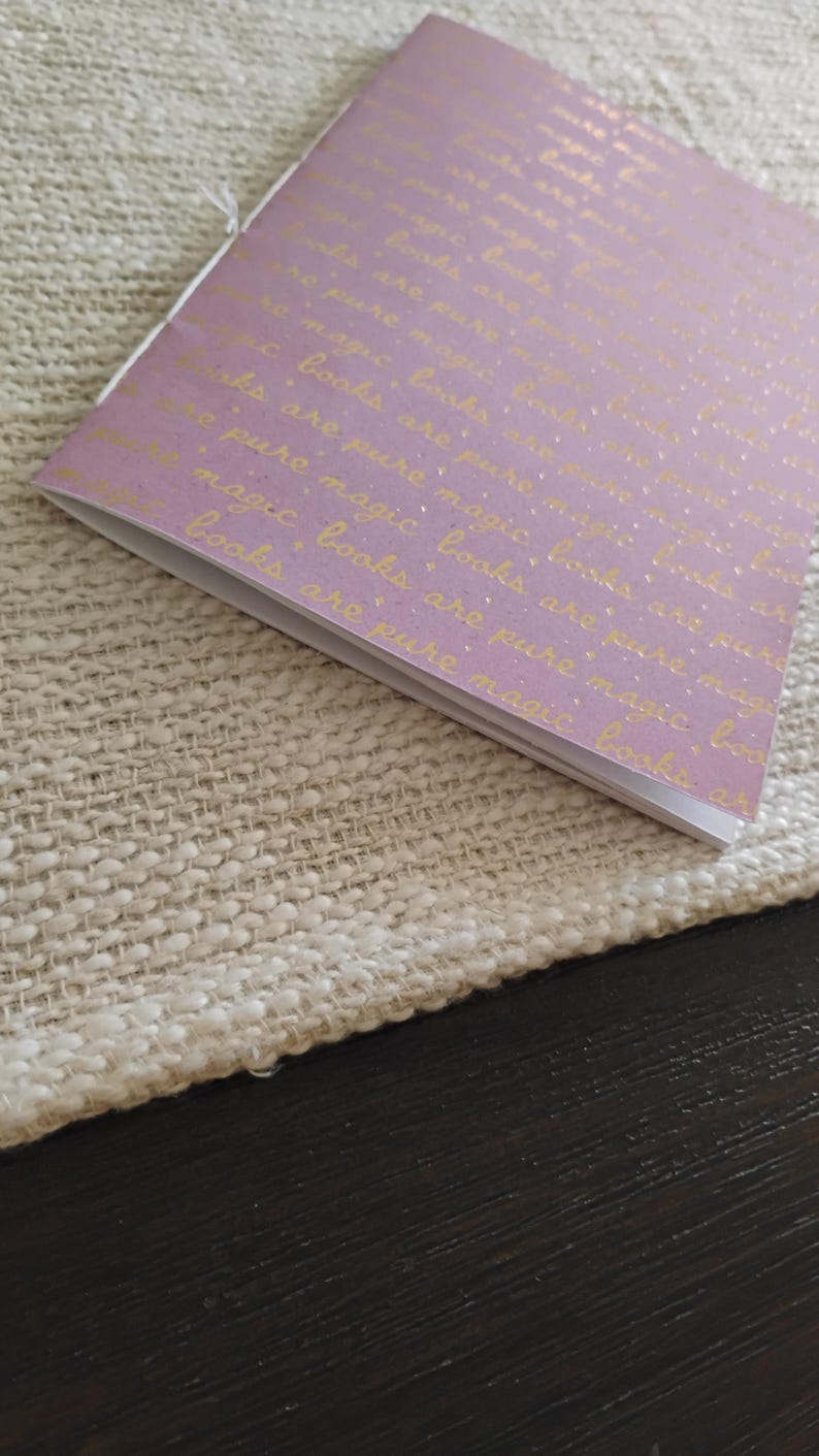 A handmade Bible study journal with a faith-inspired design. The cover features hand-lettered scripture, floral accents, and soft pastel tones. Inside, the journal includes lined, dotted, and blank pages for note-taking, prayer journaling, and reflection. Divider tabs help organize scripture studies, sermon notes, and daily devotions. Ideal for personal use or gifting, this thoughtful journal encourages spiritual growth and creativity.