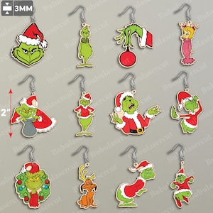 May include: A collection of Christmas-themed earrings featuring the Grinch character in various poses. The earrings are made of wood and have silver-colored hooks. The Grinch is depicted in his signature green color, wearing a Santa hat and red suit.