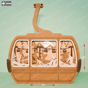 Peut inclure: Décoration en bois sur le thème du télésiège, d'environ 30 cm de haut et 28 cm de large. Le design présente des skieurs, des montagnes et un télésiège, avec une épaisseur de 3 mm. La couleur est marron clair.