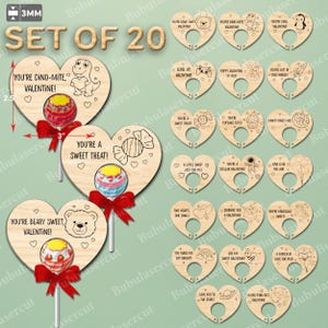 May include: Set of 20 wooden heart-shaped Valentine's Day lollipop holders. Each holder is 3 inches wide and 2.5 inches tall. Designs include a dinosaur, bear, penguin, and other cute graphics with phrases like "You're Dino-mite, Valentine!"