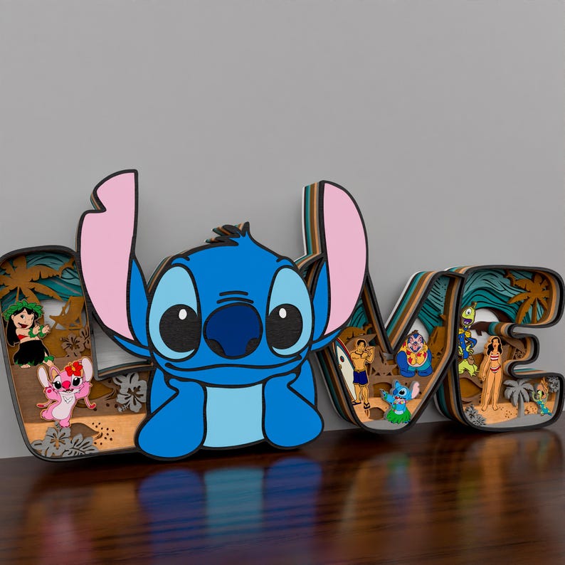 May include: A wooden cutout of the word 'LOVE' with a blue Stitch character from the Disney movie Lilo & Stitch in the center of the cutout. The letters are decorated with tropical palm trees and flowers. The Stitch character is smiling and has large eyes. There are other smaller characters from the movie in the background of the cutout.
