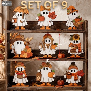 Puede incluir: Un conjunto de 9 figuras de fantasmas de madera cortadas con láser para decoración otoñal, de 17,78 cm de alto y 12,7 cm de ancho. Los fantasmas blancos tienen detalles naranjas y sostienen calabazas, hojas y cestas. 3 mm de grosor.