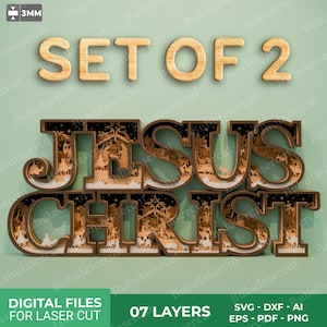May include: A layered wooden sign that reads "JESUS CHRIST" with a nativity scene design. The words "SET OF 2" are above the sign. The sign is made of seven layers and is designed for laser cutting. The image also includes the text "DIGITAL FILES FOR LASER CUT".