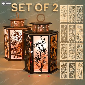 Peut inclure: Ensemble de deux lanternes en bois avec découpes florales, chacune de 17.78 cm de large et 27.94 cm de haut. Les lanternes ont une forme hexagonale et une poignée sur le dessus. Panneaux floraux supplémentaires affichés.