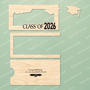 Pu&ograve; includere: Oggetti di scena per fototessere di laurea in legno tagliato al laser. Include una cornice con "CLASS OF 2026", una cornice separata, un cappello di laurea e un biglietto di congratulazioni.