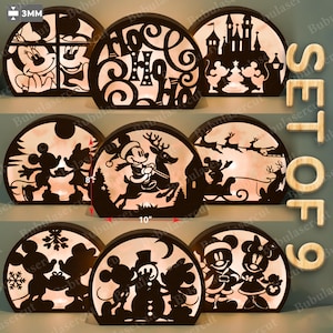 May include: A set of nine decorative wooden light-up panels, each with a different festive design. The panels are approximately 25 cm wide and 20 cm tall, with a 3mm thickness. Designs include Mickey and Minnie Mouse characters.