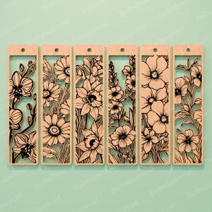 May include: Set of six wooden bookmarks featuring intricate laser-cut floral designs. Each bookmark showcases a different flower, including orchids, daisies, and daffodils, with a rectangular frame and a hole at the top for a tassel.