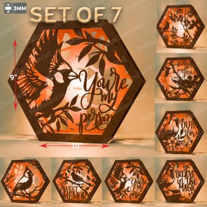 May include: Set of 7 laser-cut wooden lanterns. The main lantern is a hexagon shape, 9 inches tall and 10 inches wide, with a bird and the text "You're my person". Other lanterns feature birds and phrases like "Sweet Memory".