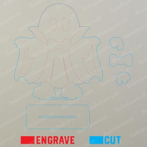 May include: A laser cut file design featuring a ghost character with a cape, a rectangular base, and separate small decorative elements. The design uses red lines to indicate areas for engraving and blue lines to indicate areas for cutting.