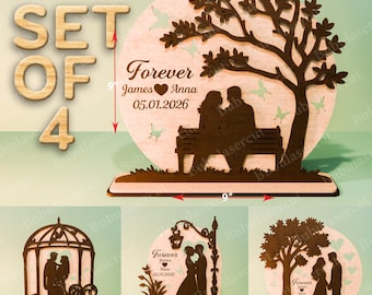 May include: A set of four wooden wedding decorations. The main piece features a couple on a bench under a tree, with the text "Forever James Anna 05.01.2026". The set includes a gazebo, a lamppost, and a tree design, all in a natural wood finish.
