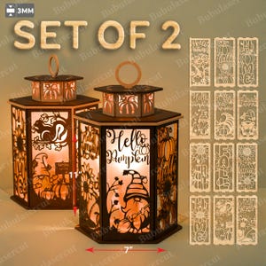May include: Set of 2 wooden lanterns with intricate cut-out designs, including pumpkins, sunflowers, and a gnome. Each lantern is approximately 7 inches wide and 11 inches tall. The phrase "Hello Pumpkin" is featured on one lantern. Additional decorative panels are included.