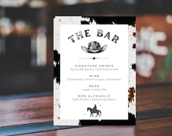 May include: A black and white sign with a cowhide pattern background. The sign says "THE BAR" in a black and white font with a cowboy hat graphic. The sign lists signature drinks, wine, beer, and non-alcoholic options.