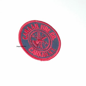 May include: A red and gray embroidered patch with the text "Camak Fire Co. Company" in a circle.