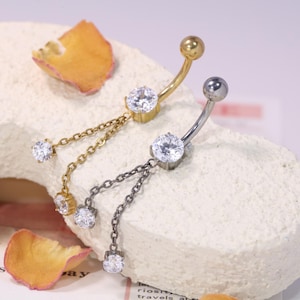 May include: A set of three ceramic mugs with a speckled, matte finish. The mugs are in shades of cream, light gray, and dark gray. Each mug has a simple, minimalist design, perfect for coffee or tea.