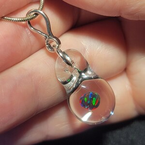 Hand blown glass and black Gilson opal pendant in sterling silver.  I call this teardrop dangle necklace design “Mermaid’s tears”.