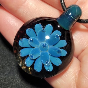 Hand blown glass implosion pendant, handmade borosilicate glass necklace, with sparkly blue/green flower.  Unisex blown glass jewelry.