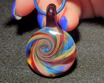 Handmade borosilicate glass pendant, in my unique multi color necklace with a reversible vortex window design !