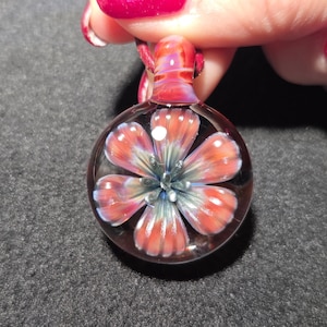 May include: A white ceramic mug with a black handle and the text "But first, coffee" in a black, handwritten-style font. The mug is on a white surface.