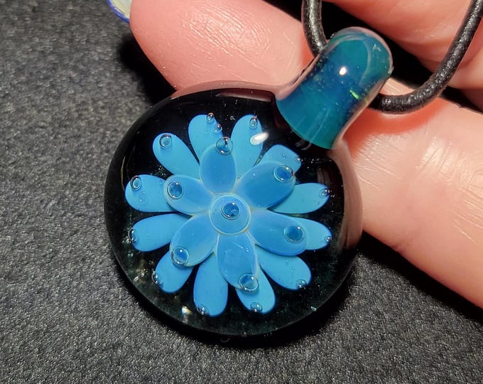 Hand blown glass implosion pendant, handmade borosilicate glass necklace, with patina blue flower.  Unisex blown glass jewelry.